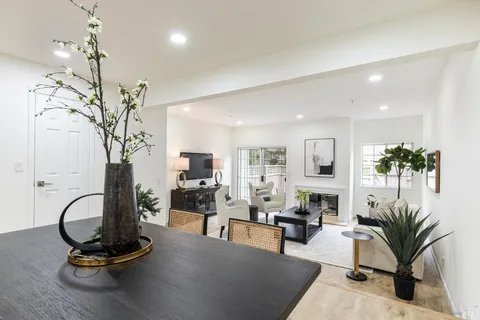 a living room with furniture gym equipment and a chandelier
