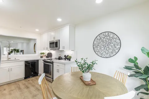 a living room with furniture potted plant and a table