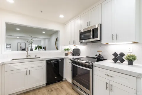 a kitchen with a sink stove and microwave