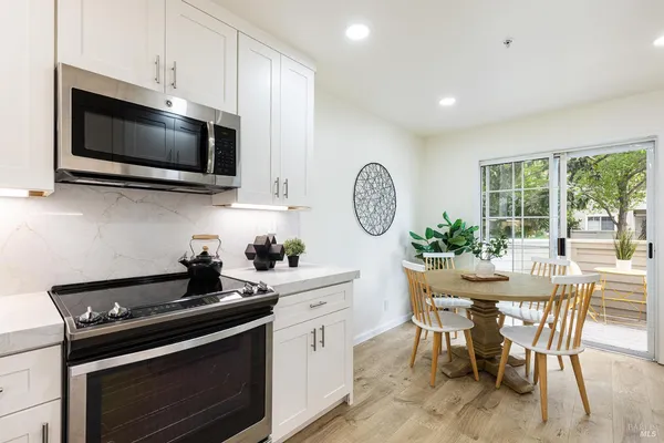 a kitchen with a sink stainless steel appliances and cabinets