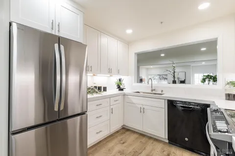 a kitchen with a table and refrigerator