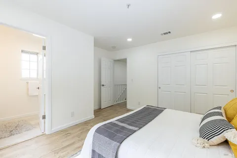 a bedroom with a bed and a large window