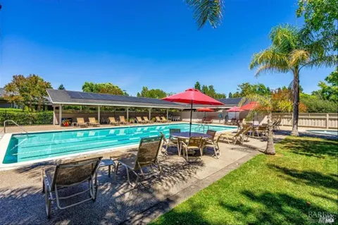 a view of a swimming pool with a yard