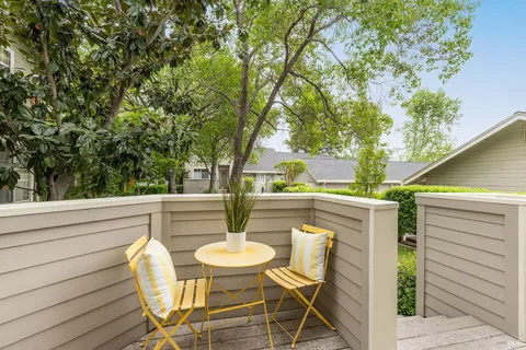 a view of outdoor dining space with a table and chairs