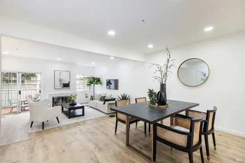 a living room with furniture a mirror and a table
