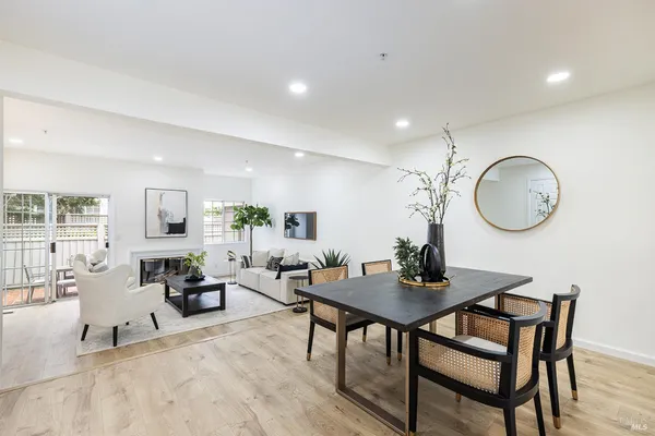 a living room with furniture a mirror and a table