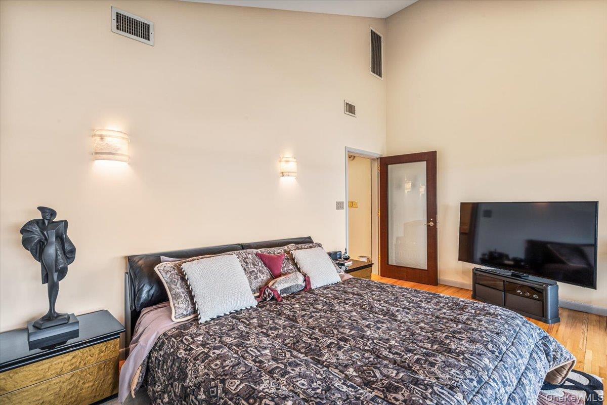154-43 Riverside Drive Queens, NY 11357 - Photo 29 of 41 a bedroom with a bed and a flat screen tv