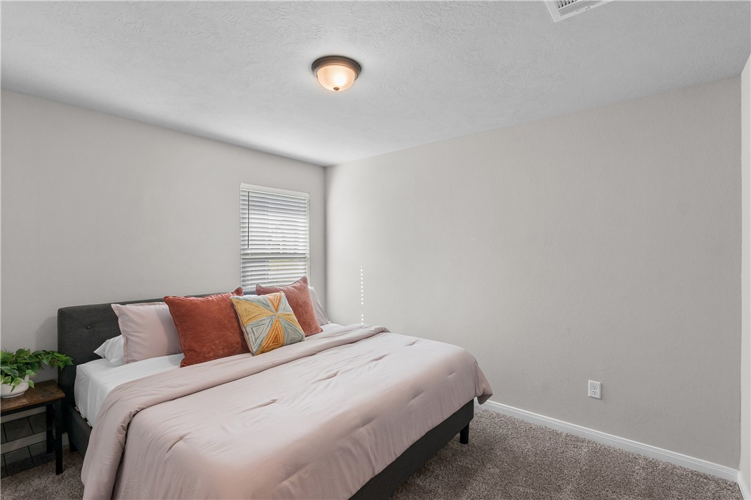 1925 Viva Road Bryan, TX 77807 - Photo 19 of 25 Bedroom with carpet flooring and a textured ceiling