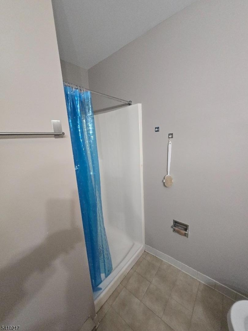 666 Mill Street, Unit 11 Belleville, NJ 07109 - Photo 8 of 13 an empty room with windows