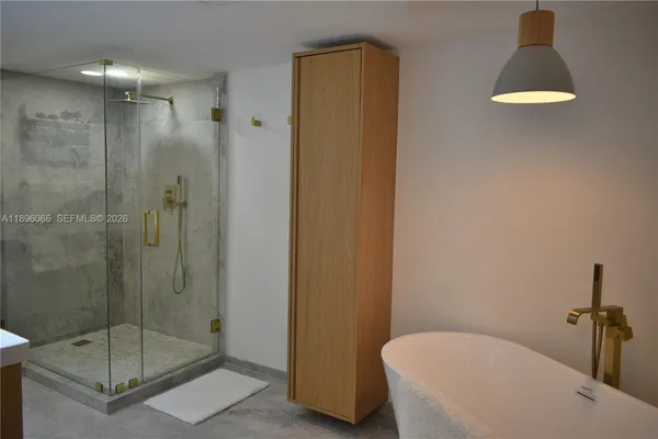 a bathroom with a shower a toilet and sink