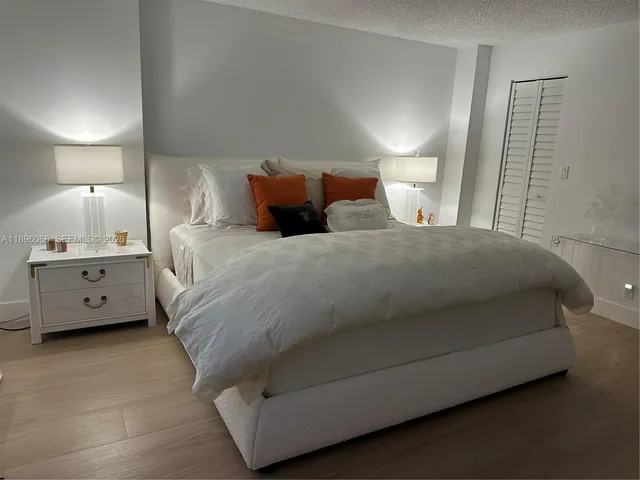 a large bedroom with a bed and a lamp