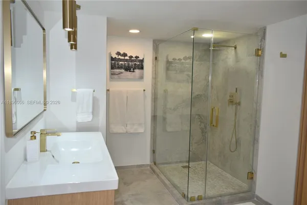 a bathroom with a shower and a sink