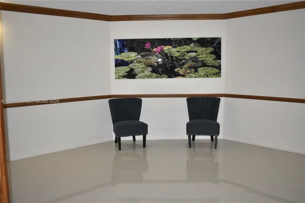 a view of a hallway with wooden floor and cabinet