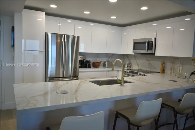 a kitchen with a sink refrigerator and cabinets