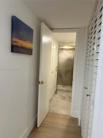 a white tub sitting next to a shower