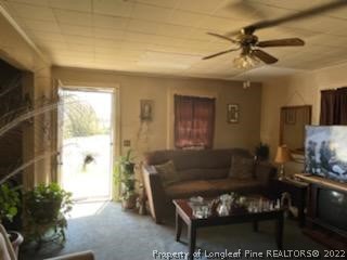 6563 Robinson Bridge Road, Unit A Morven, NC 28119 - Photo 8 of 9 a living room with furniture a chandelier and a window
