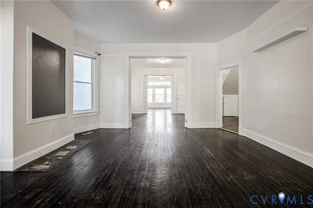 wooden floor in an empty room with a window