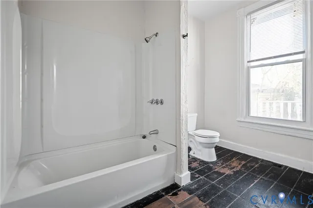 a bathroom with a bathtub and a toilet