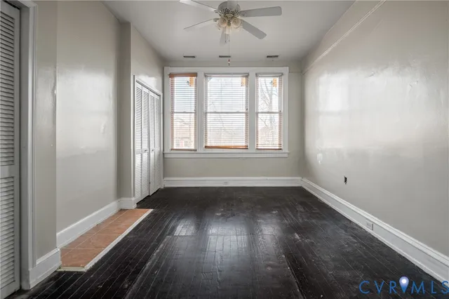 wooden floor in an empty room with a window