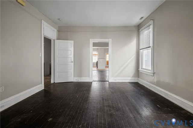 wooden floor in an empty room with a window