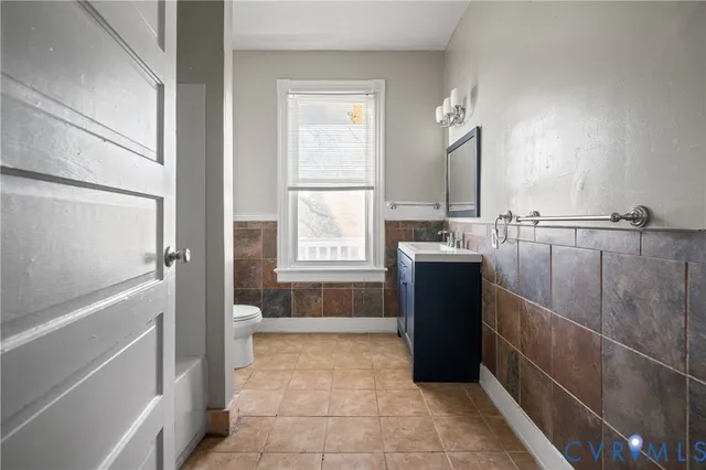 a bathroom with a double vanity sink and mirror