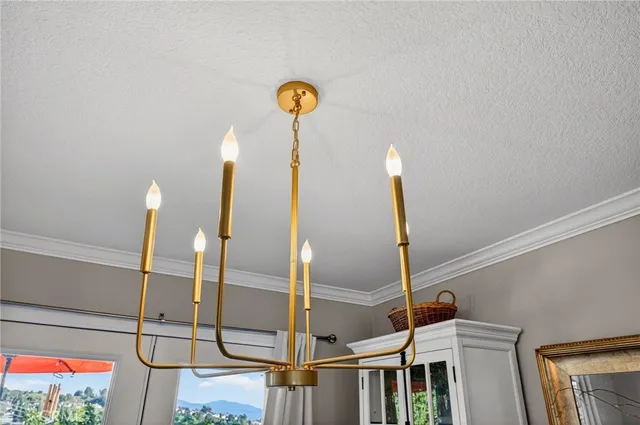 a kitchen with stainless steel appliances granite countertop a dining table chairs refrigerator and microwave