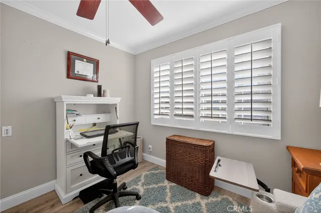 a bedroom with a bed and lamp on the dresser