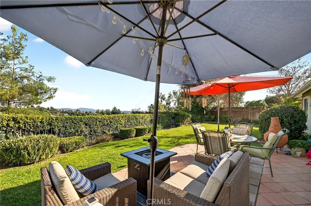 a view of backyard with outdoor seating and green space