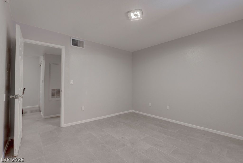 7885 West Flamingo Road, Unit 1016 Las Vegas, NV 89147 - Photo 17 of 24 A well-lit room showcasing durable tile flooring and a neutral palette, offering a blank canvas for personalization.