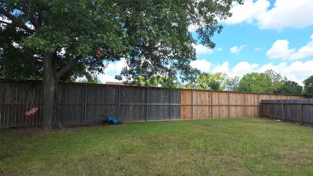 a view of a backyard with a small cabin and a chair