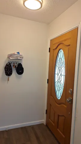 a view of a chair and table on the deck in front of house