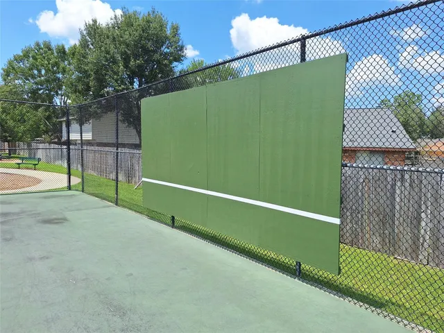 a view of a white house with a small yard and plants