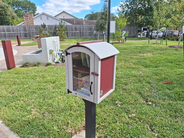 a bathroom with a vanity and a view of a painting