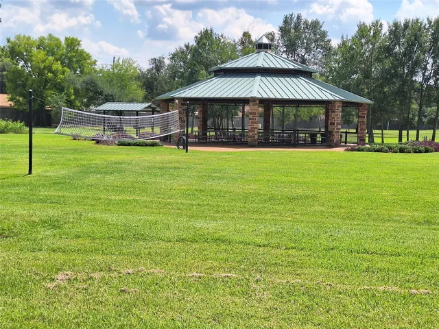 a view of a large garden with a small house in the background