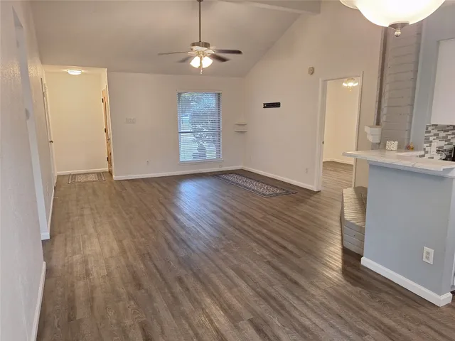 wooden floor in an empty room with a window