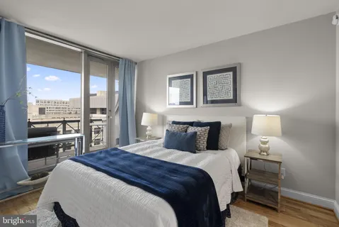 a bedroom with a large bed and a lamp