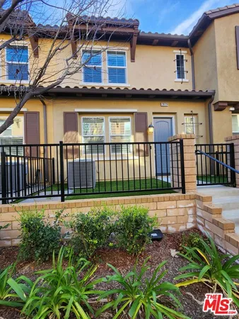 a view of a house with a yard and sitting area