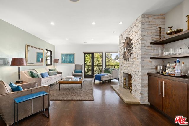 a dining room with furniture and a floor to ceiling window