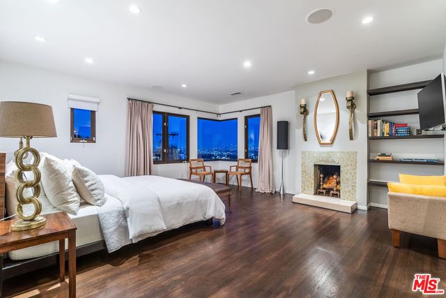 a balcony with wooden floor and outdoor seating