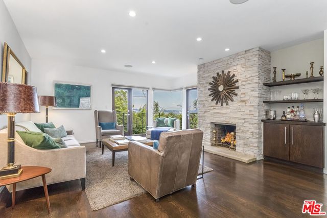 a living room with furniture a rug and a fireplace