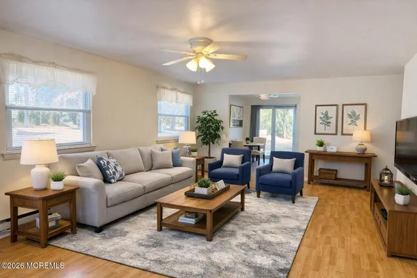 a living room with furniture a chandelier a lamp on table and a window