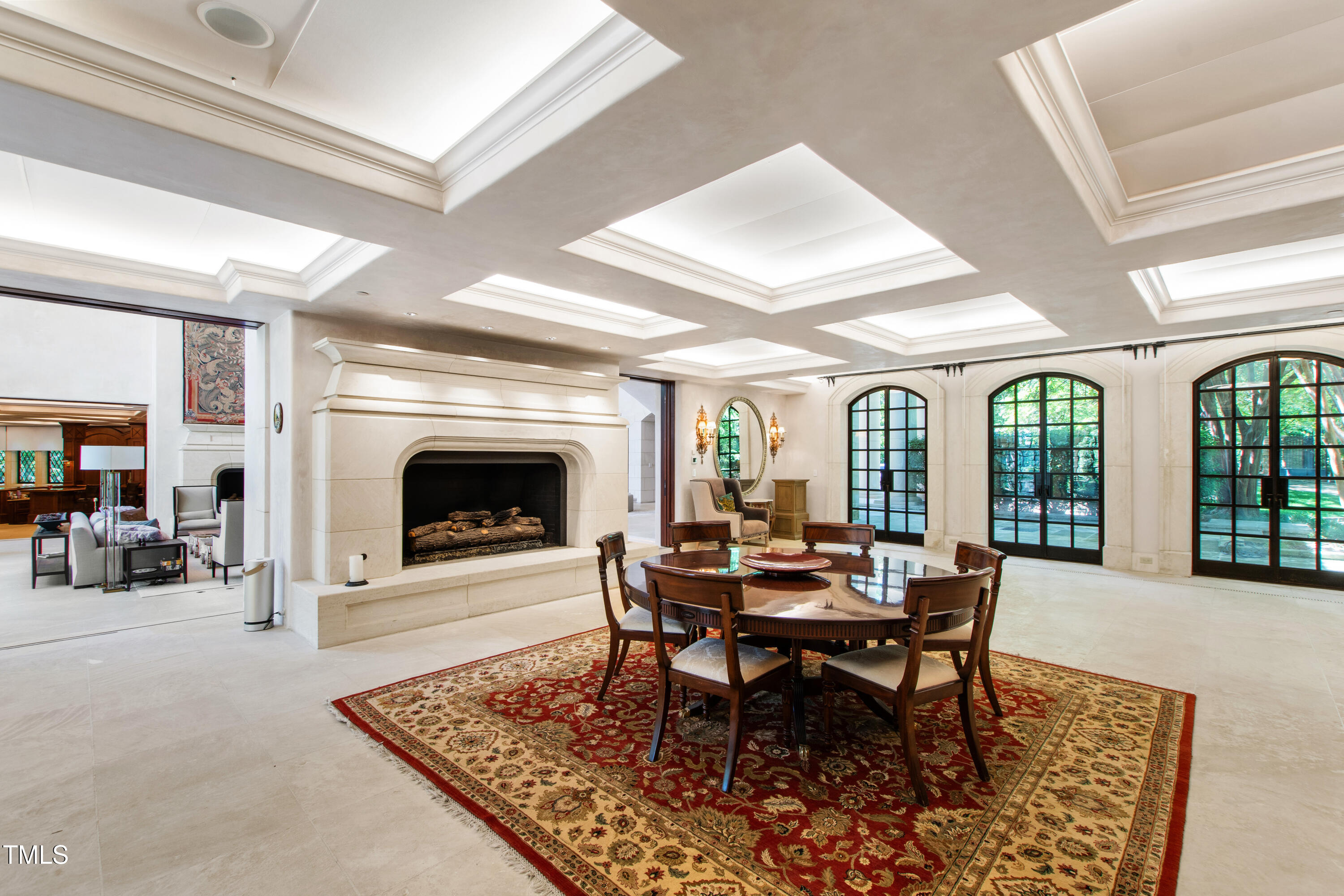 6510 New Market Way Raleigh, NC 27615 - Photo 20 of 95 a dining room with furniture a rug and a fireplace