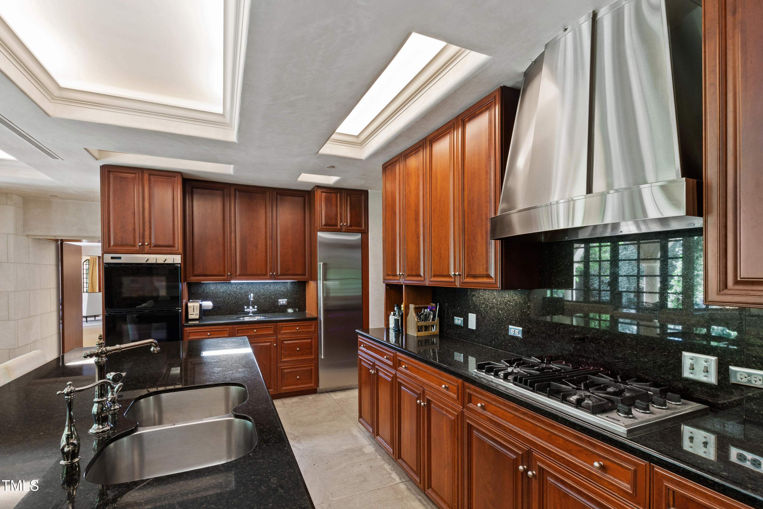 6510 New Market Way Raleigh, NC 27615 - Photo 25 of 95 a kitchen with stainless steel appliances a stove a sink and a microwave