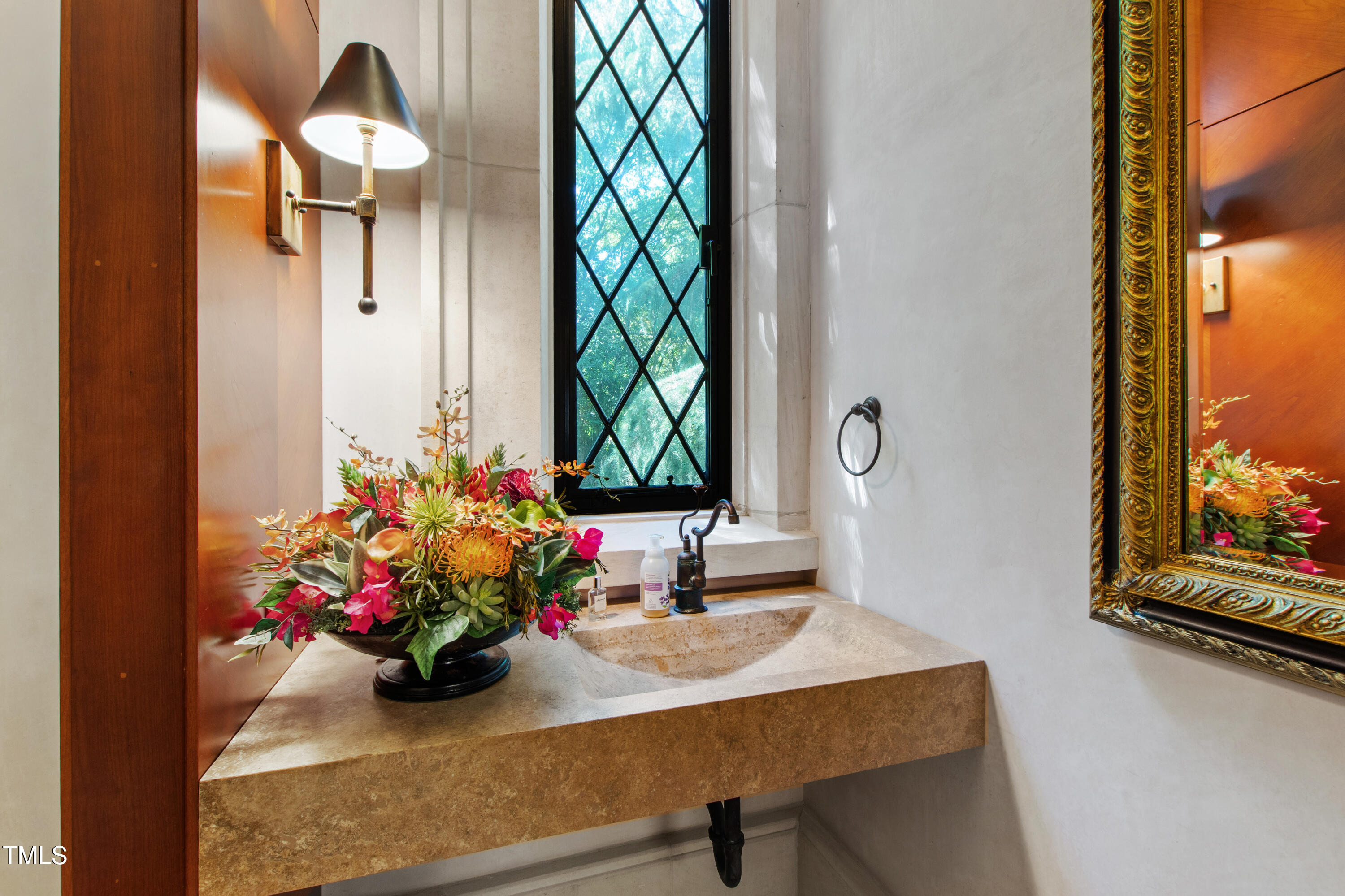 6510 New Market Way Raleigh, NC 27615 - Photo 38 of 95 a bathroom with a sink a mirror and a window