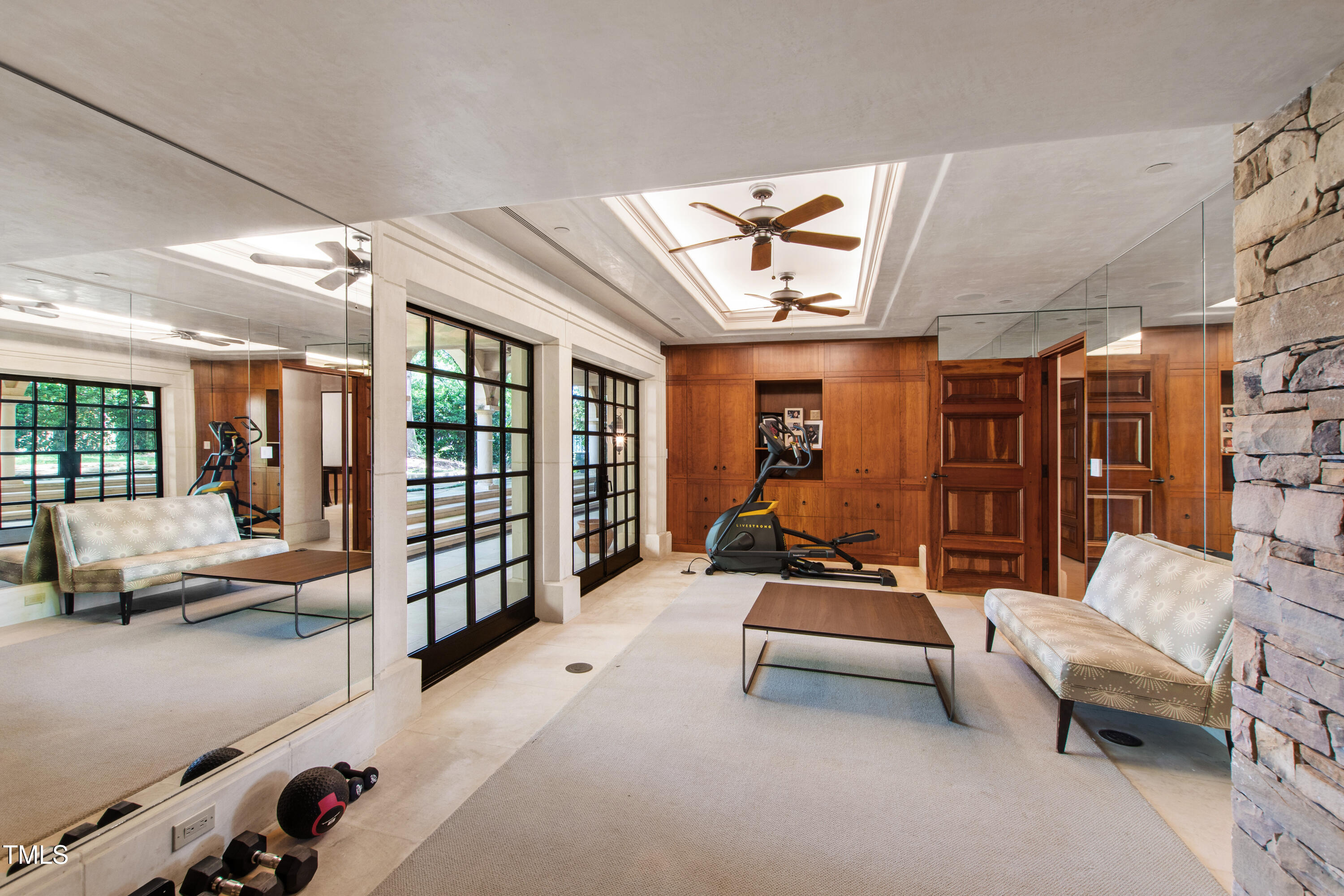 6510 New Market Way Raleigh, NC 27615 - Photo 44 of 95 a living room with furniture gym equipment and a large window