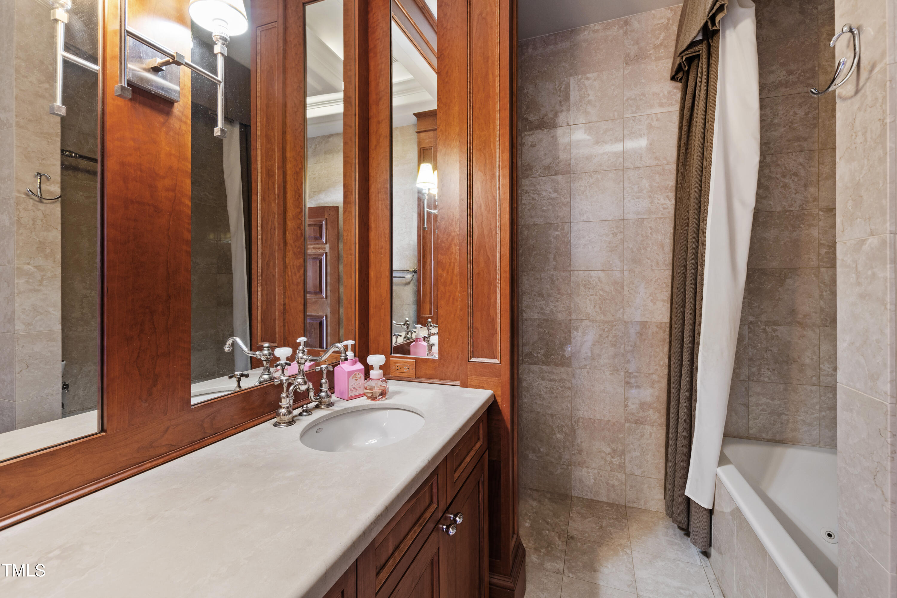 6510 New Market Way Raleigh, NC 27615 - Photo 58 of 95 a bathroom with a double vanity sink and a bathtub