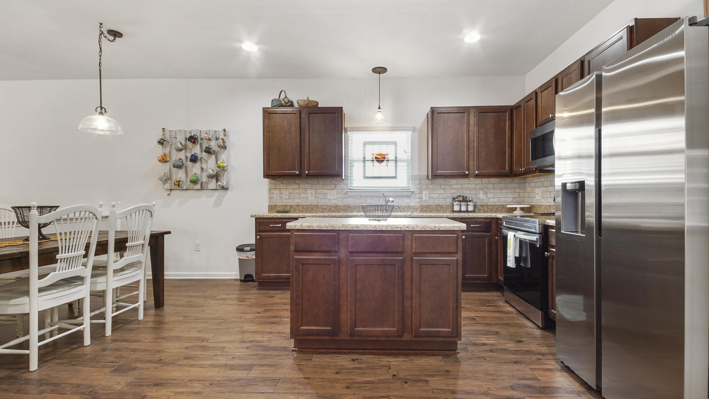 237 Nelly Street Freeport, FL 32439 - Photo 7 of 42 a kitchen with kitchen island granite countertop cabinets and stainless steel appliances