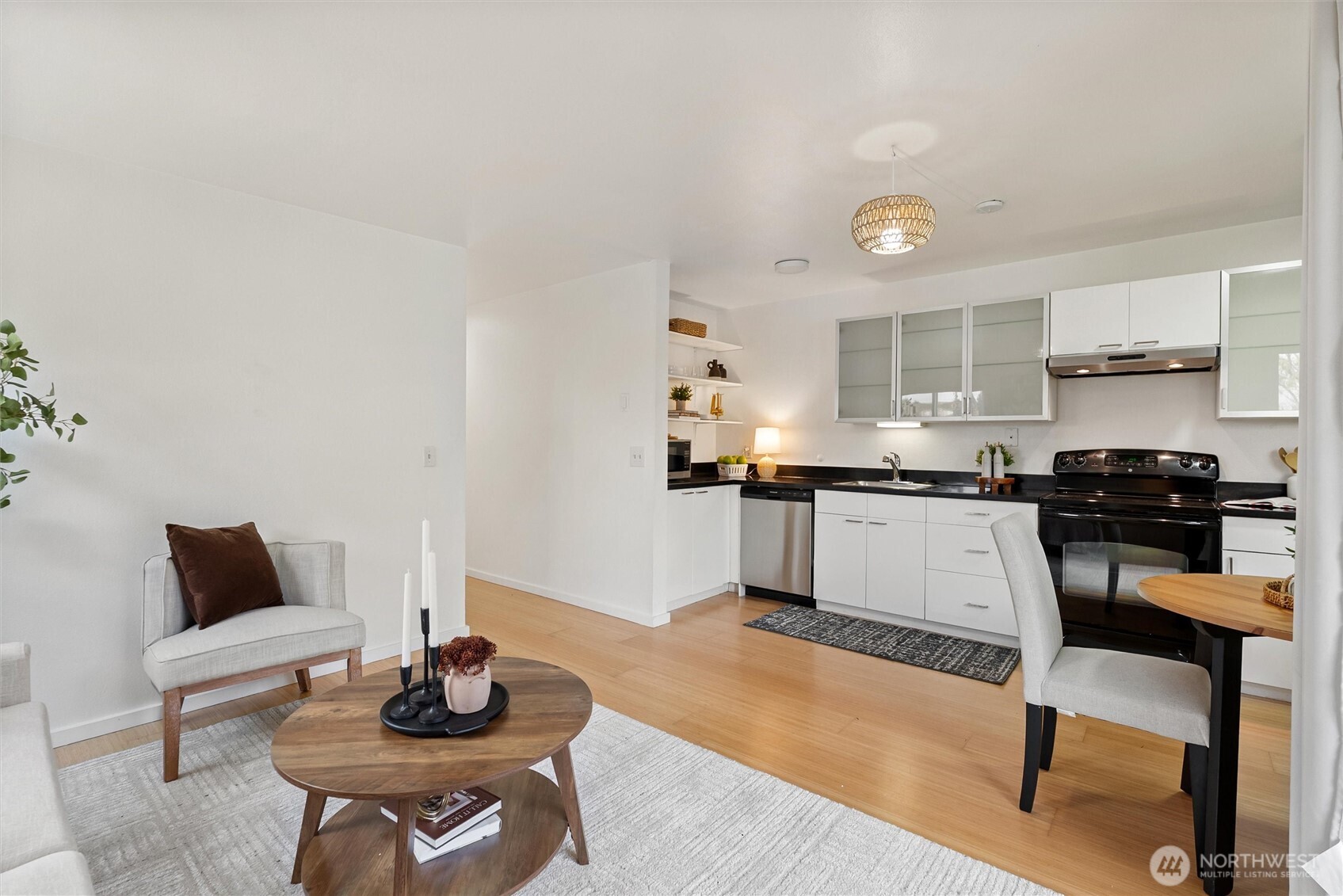 2626 East Madison Street, Unit 11 Seattle, WA 98112 - Photo 19 of 29 a kitchen with stainless steel appliances kitchen island granite countertop a sink and cabinets