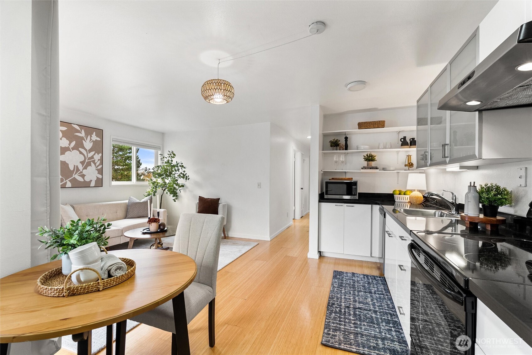 2626 East Madison Street, Unit 11 Seattle, WA 98112 - Photo 20 of 29 a kitchen with stainless steel appliances a table and chairs in it