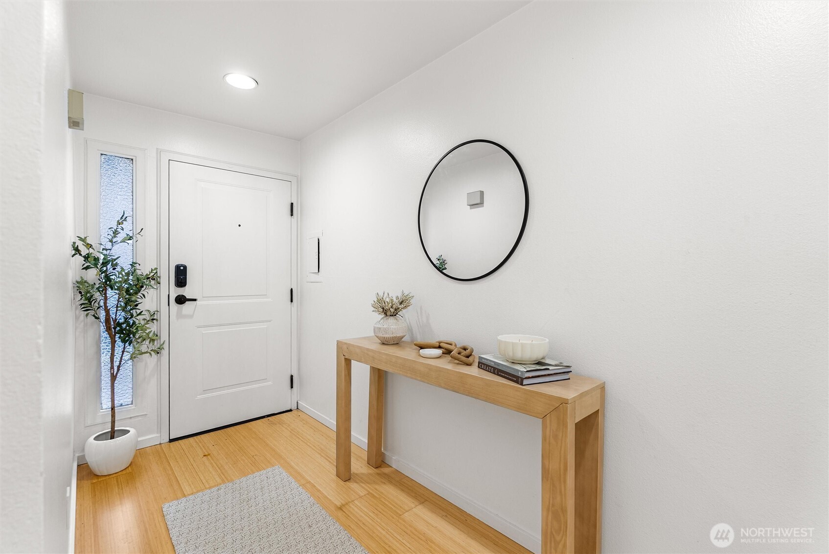 2626 East Madison Street, Unit 11 Seattle, WA 98112 - Photo 3 of 29 a room with a mirror and a potted plant